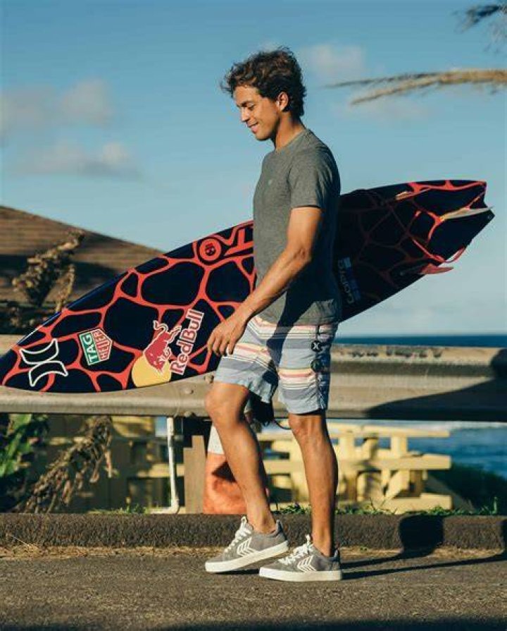 How do surfers stay low?