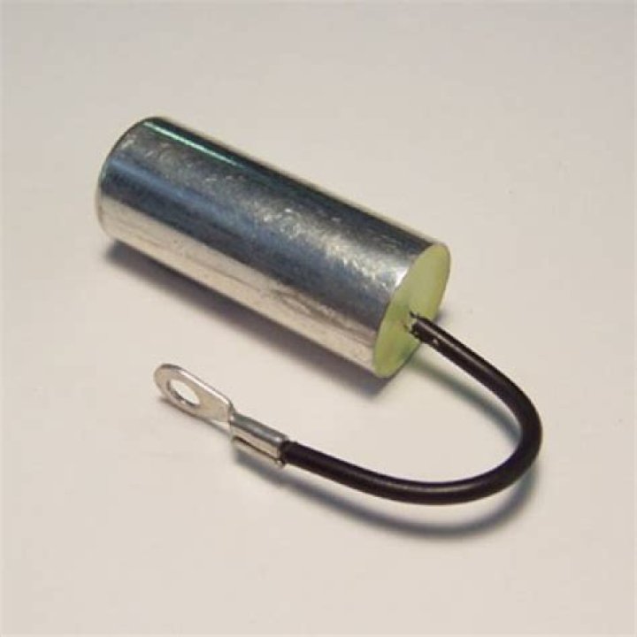 What does the condenser do in a magneto?